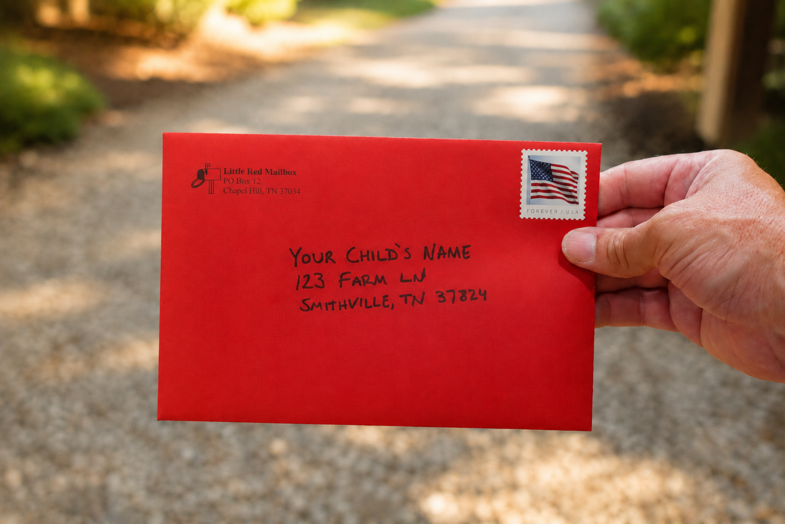 Hand holding a Little Red Mailbox envelope with a Forever stamp